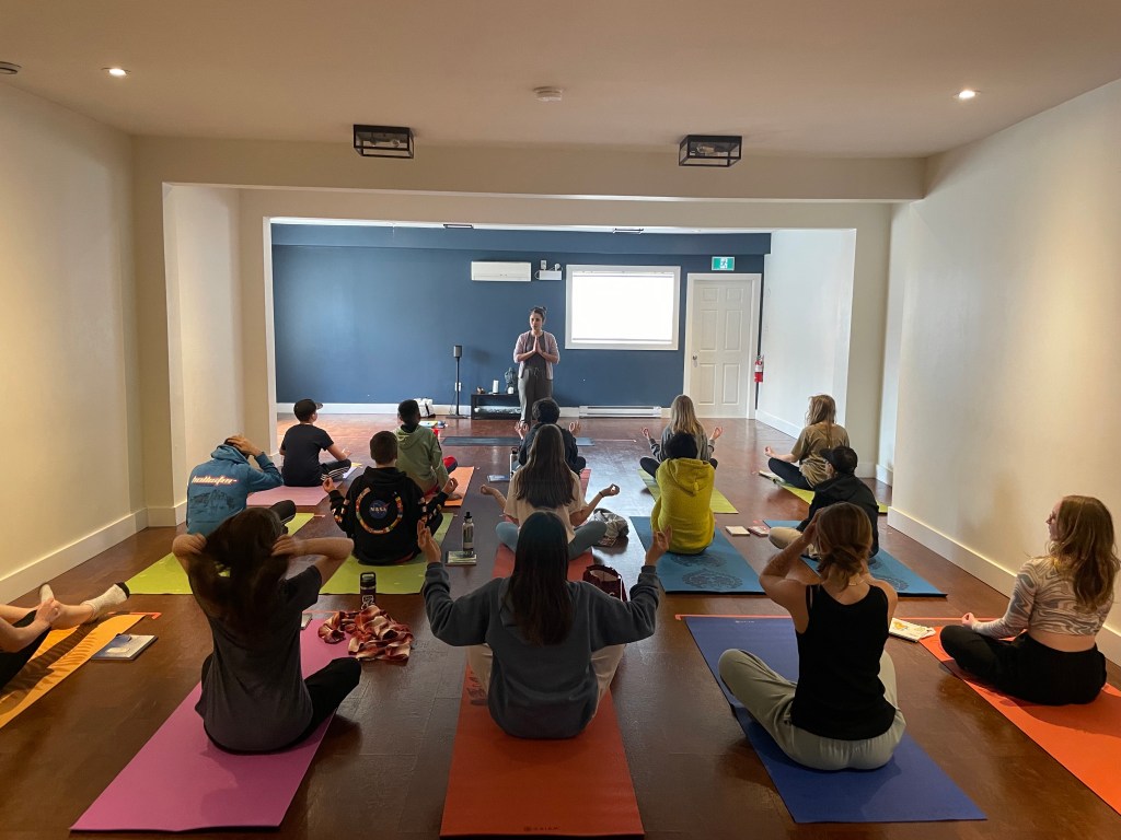 youth practicing yoga as part of a program